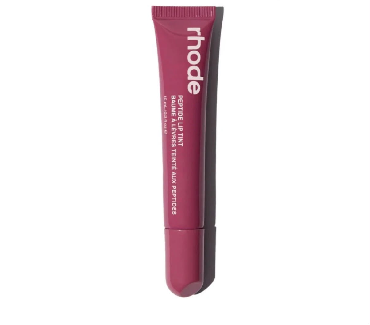 Rhode Peptide Lip Tint tube in Raspberry Jelly, a berry pink, on white background