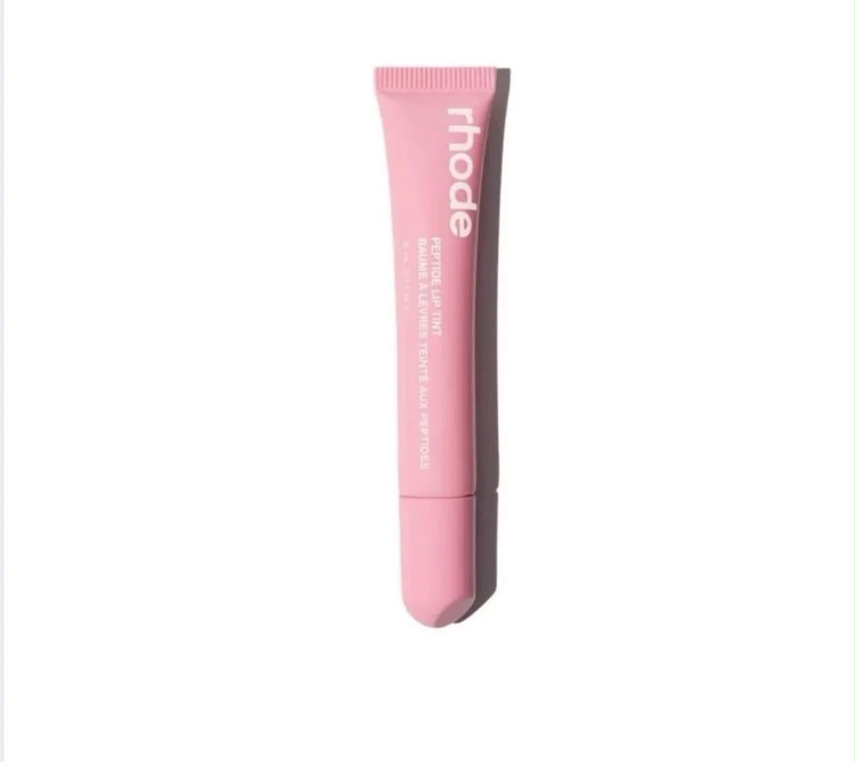 Rhode Peptide Lip Tint tube in Ribbon, a sheer pink, on white background