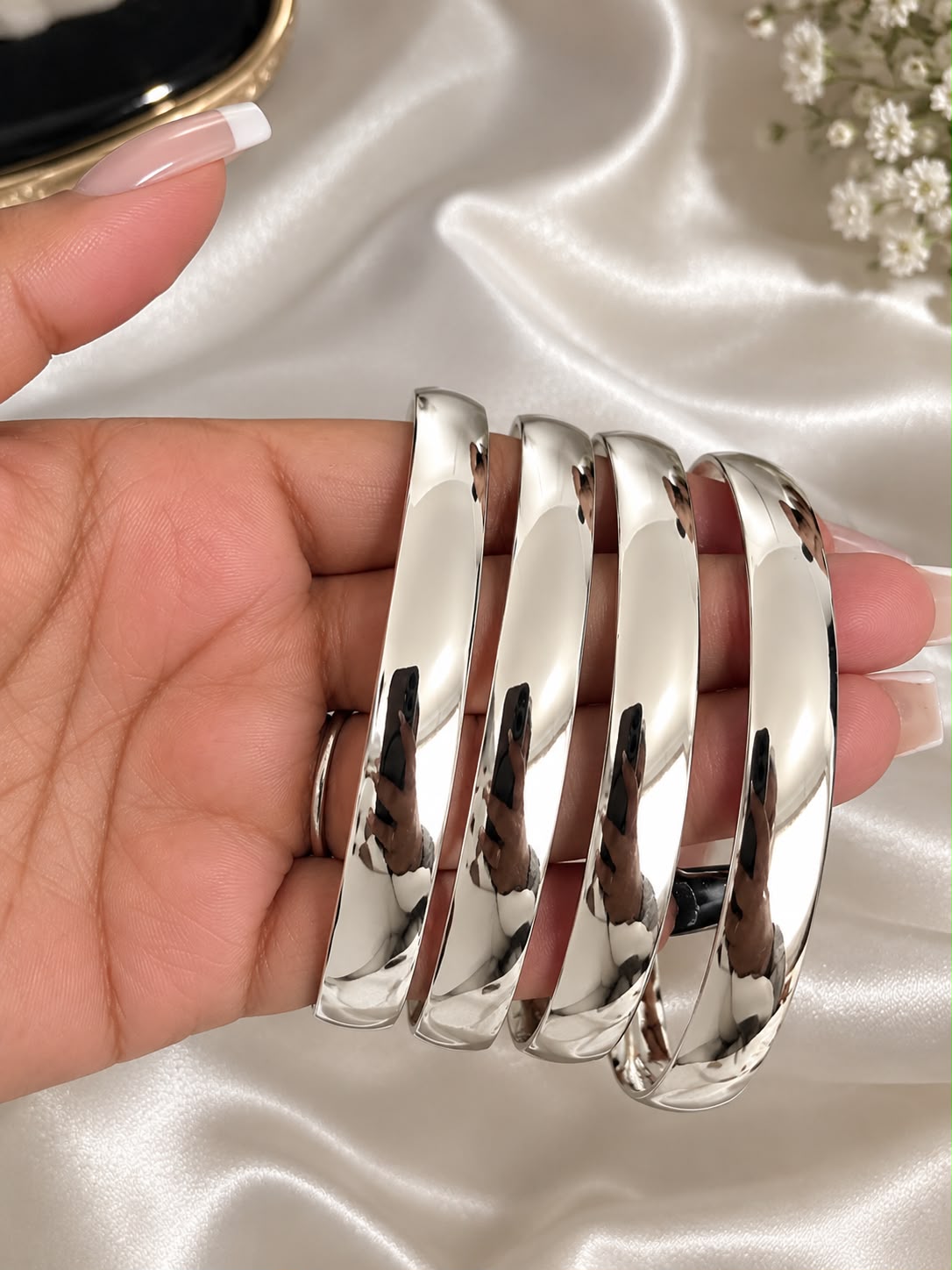 pair of chunky silver plated bangles, 6.2cm wide, on wrist