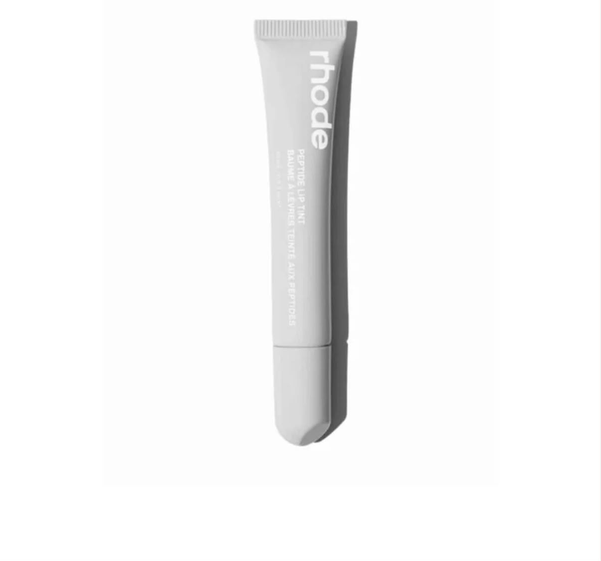 Rhode Peptide Lip Tint tube in Unscented, pale grey, on white background