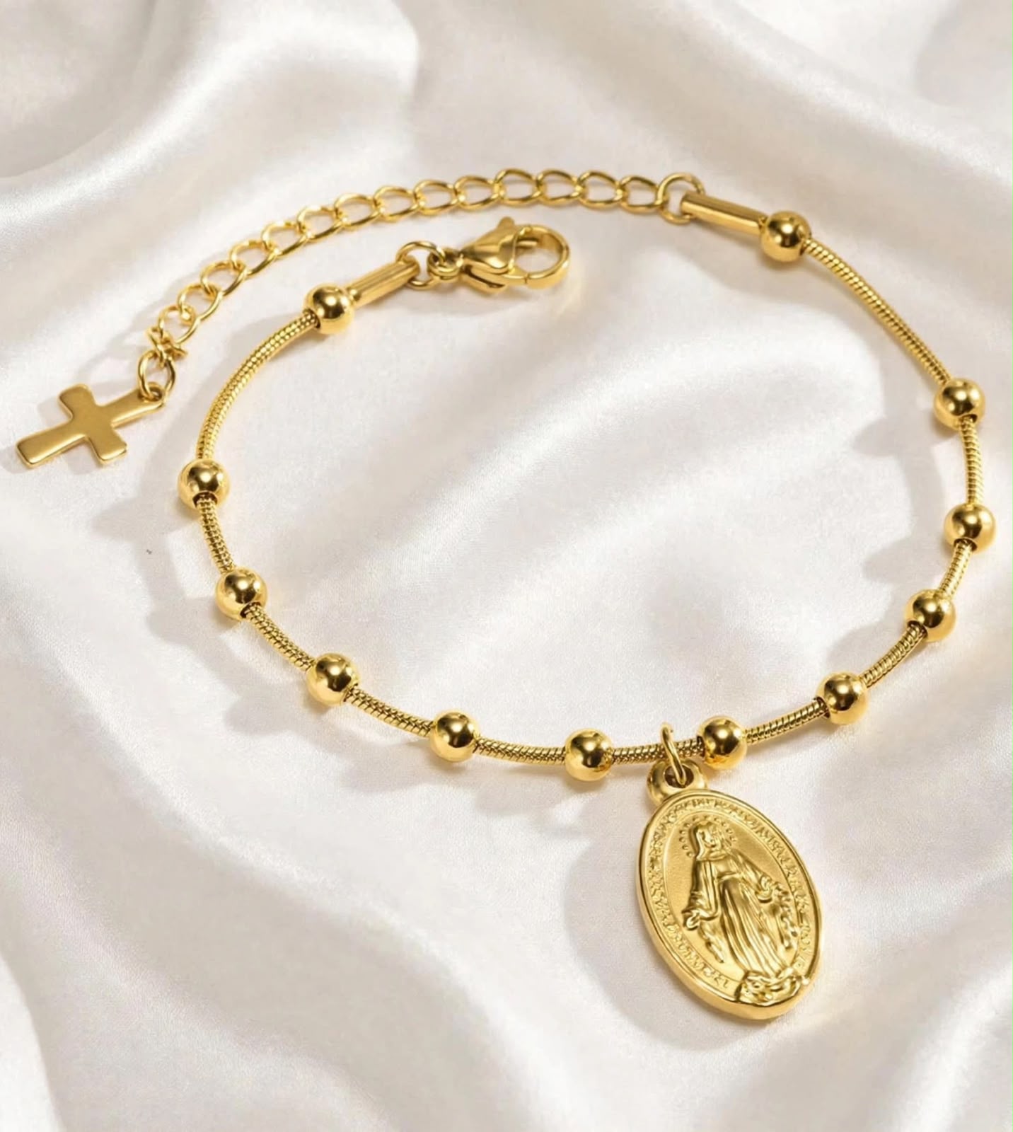 gold plated Virgin Mary medallion charm bracelet on satin fabric