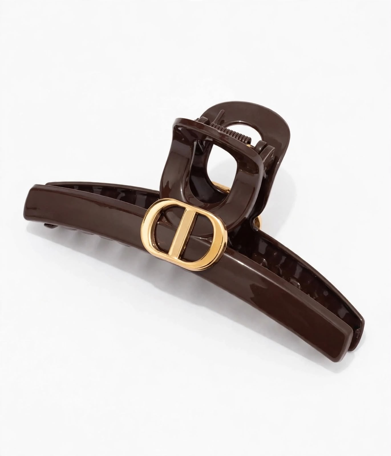 brown DD hair claw clip with a gold-tone emblem on white background