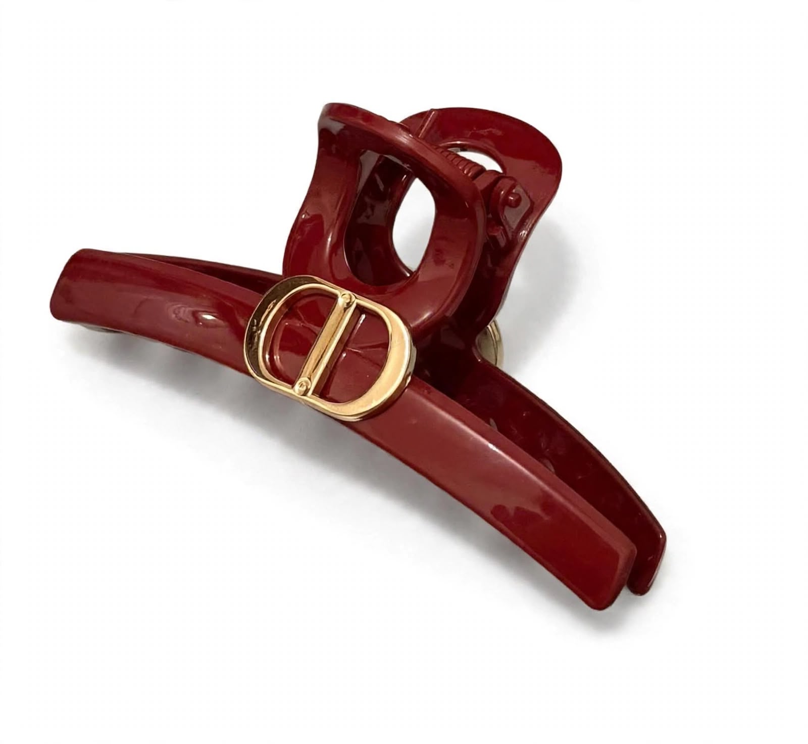 burgundy DD hair claw clip with a gold-tone emblem on white background
