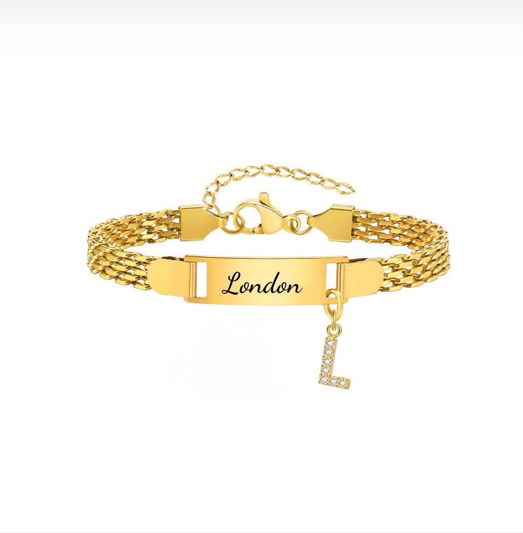 gold personalised name bracelet engraved London with a stone-set letter L charm on white background